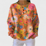 Faustine – Orange Jumper with Colourful Floral Pattern